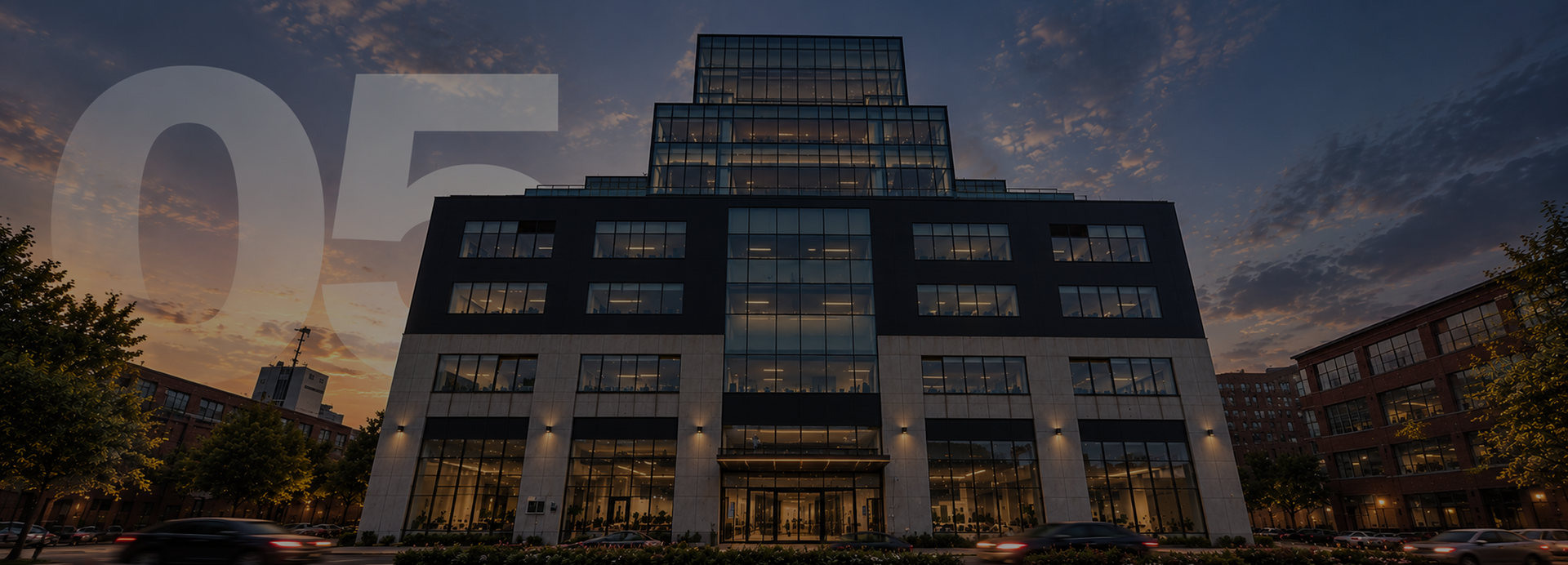Modern glass office building at dusk with large “05” overlay and a cloudy sky.
