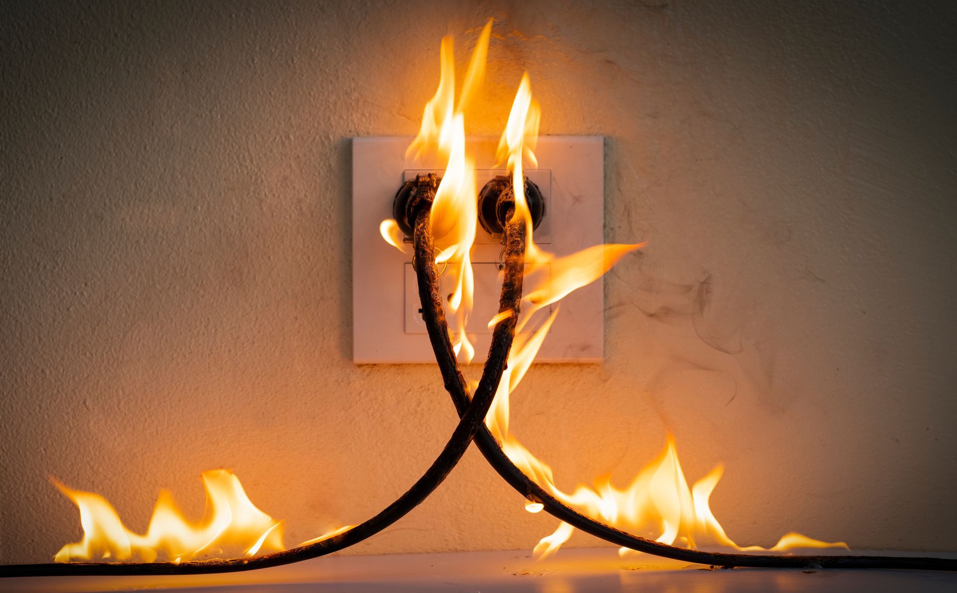 plugged-in extension cords on fire.
