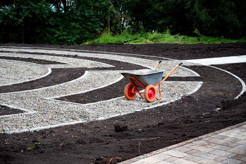 A wheelbarrow is sitting in the middle of a labyrinth.
