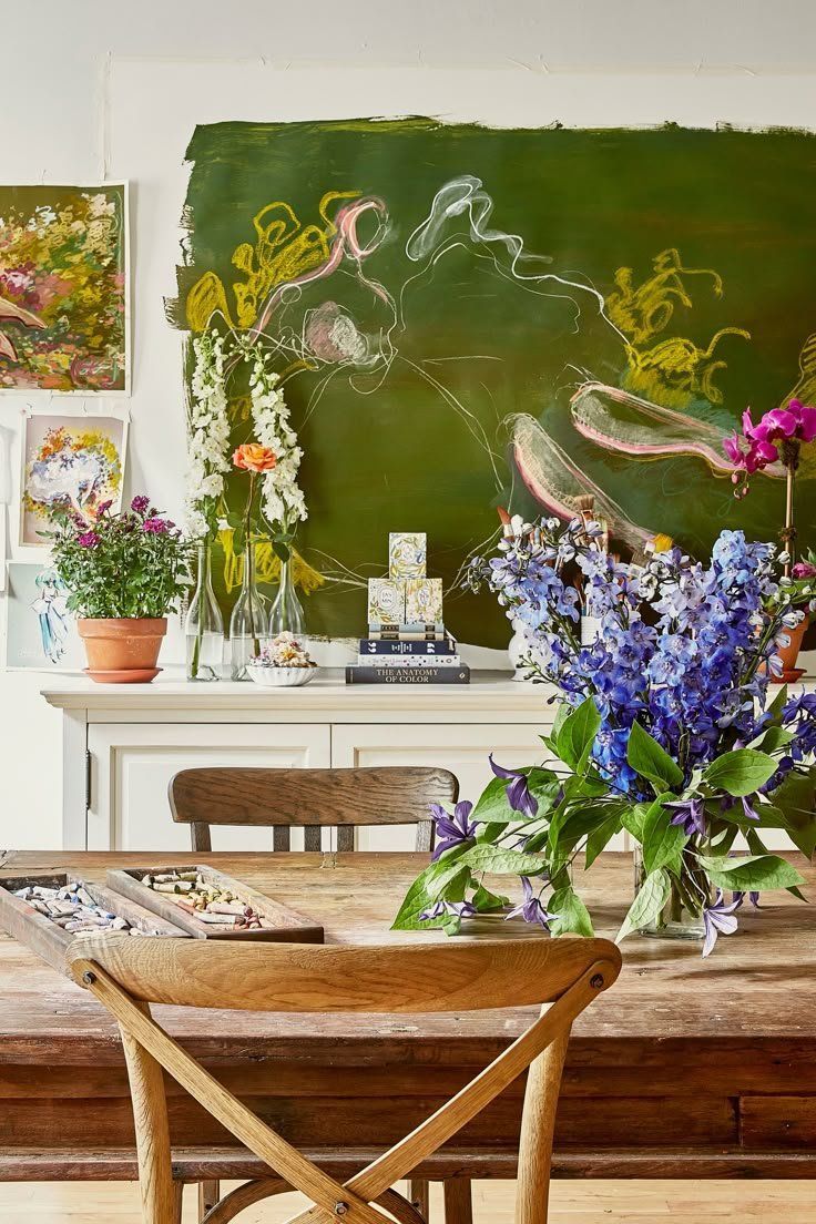 Dining Room With Wooden Table, Floral Bouquet And Painting On The Wall — Everyday Interiors in Helensburgh, NSW
