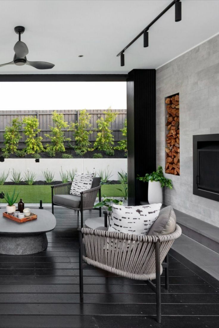 Modern Patio With Wicker Chairs, Round Table, And A Wall Fireplace — Everyday Interiors in Helensburgh, NSW