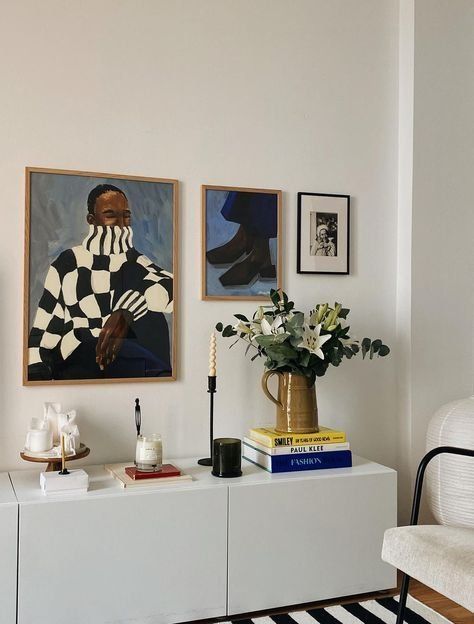 Framed Art Above A White Cabinet With Candles, Books And Flowers — Everyday Interiors in Helensburgh, NSW