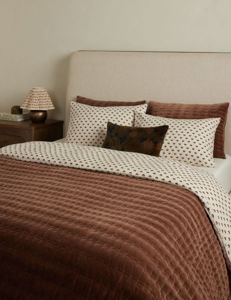 Cozy Bed With Brown And Cream Bedding, Pillows And A Small Lamp — Everyday Interiors in Helensburgh, NSW