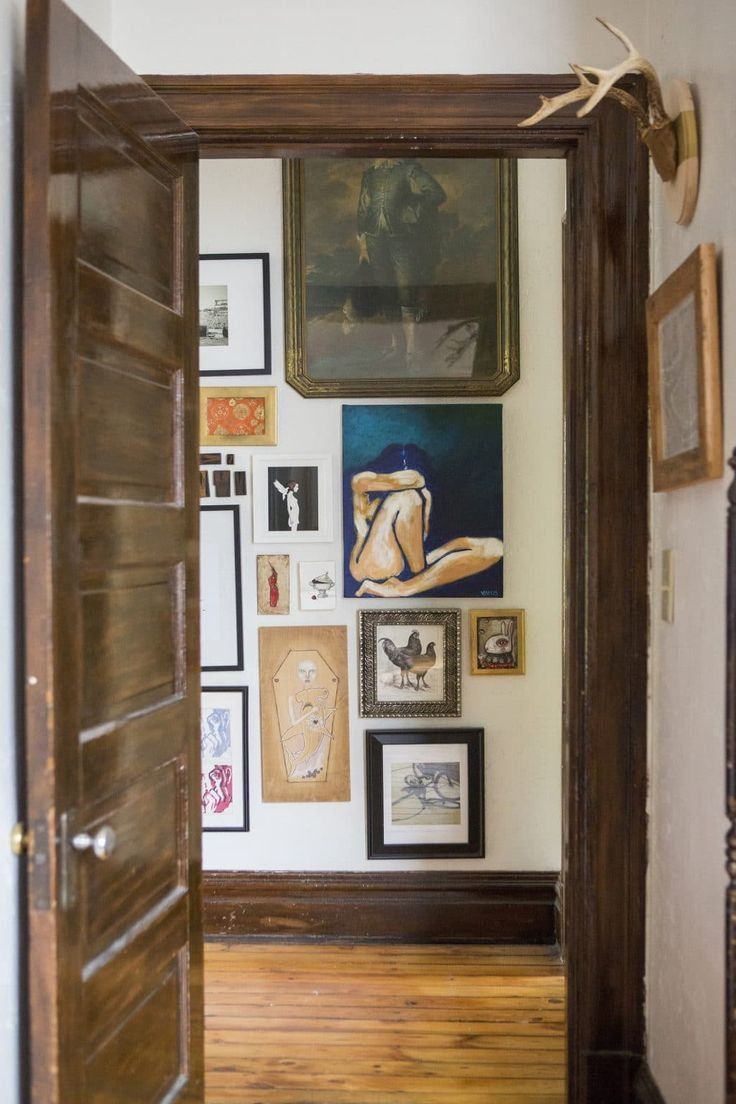 Open Doorway To A Room With A Gallery Wall Of Framed Artwork — Everyday Interiors in Helensburgh, NSW