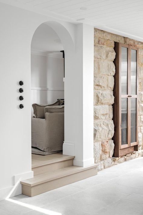 Modern White Entryway With An Arched Doorway And Stone Wall — Everyday Interiors in Helensburgh, NSW