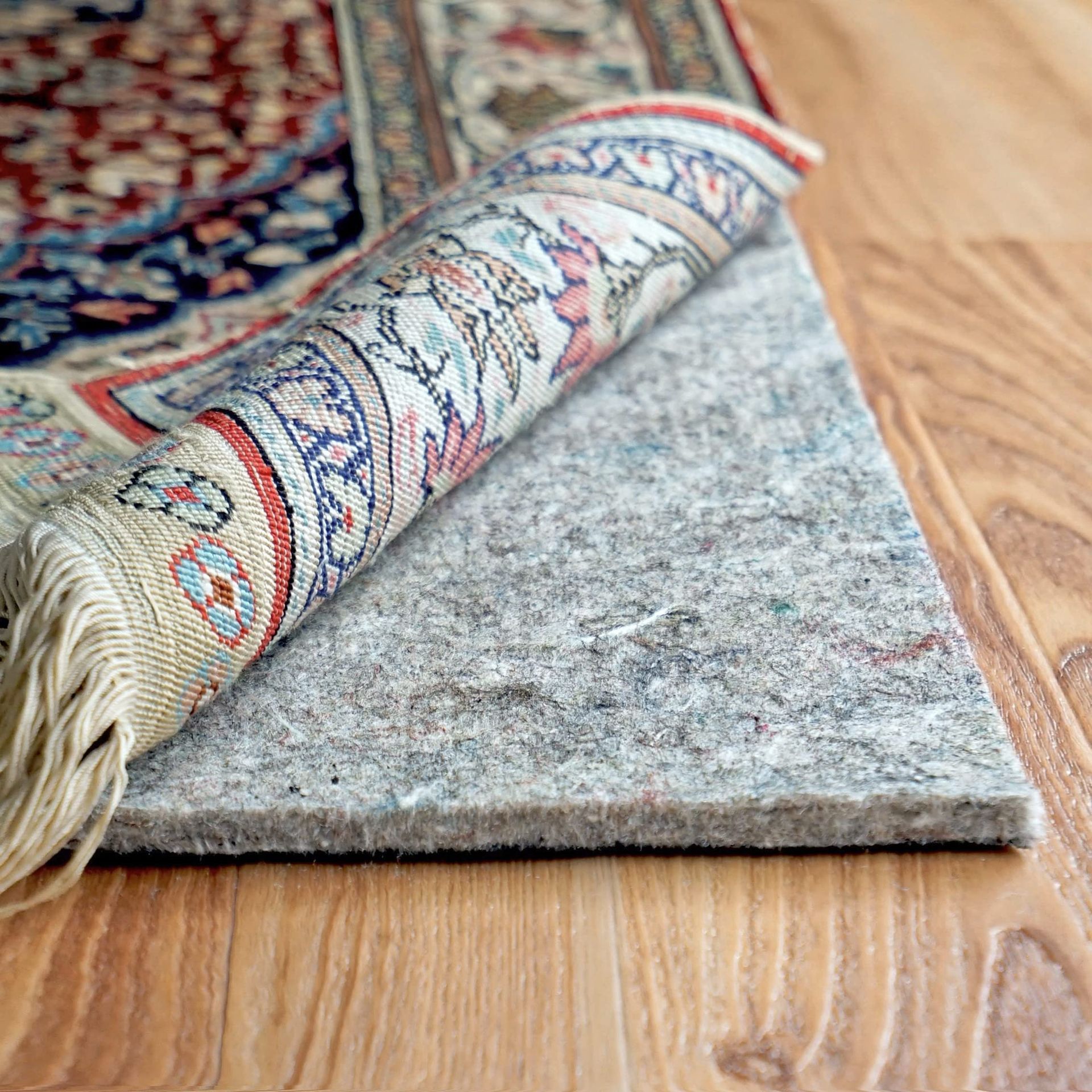 Rolled Patterned Rug On A Wooden Floor, Showing The Rug’s Underside — Everyday Interiors in Helensburgh, NSW