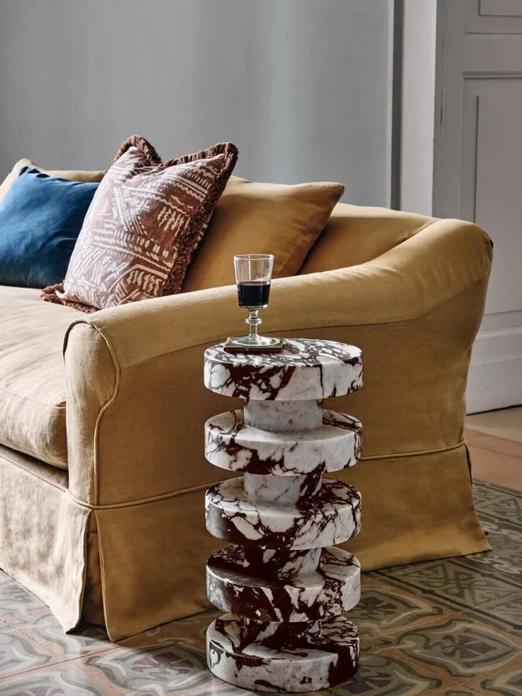 Marble Side Table With A Drink Beside A Beige Sofa With Colorful Pillows — Everyday Interiors in Helensburgh, NSW