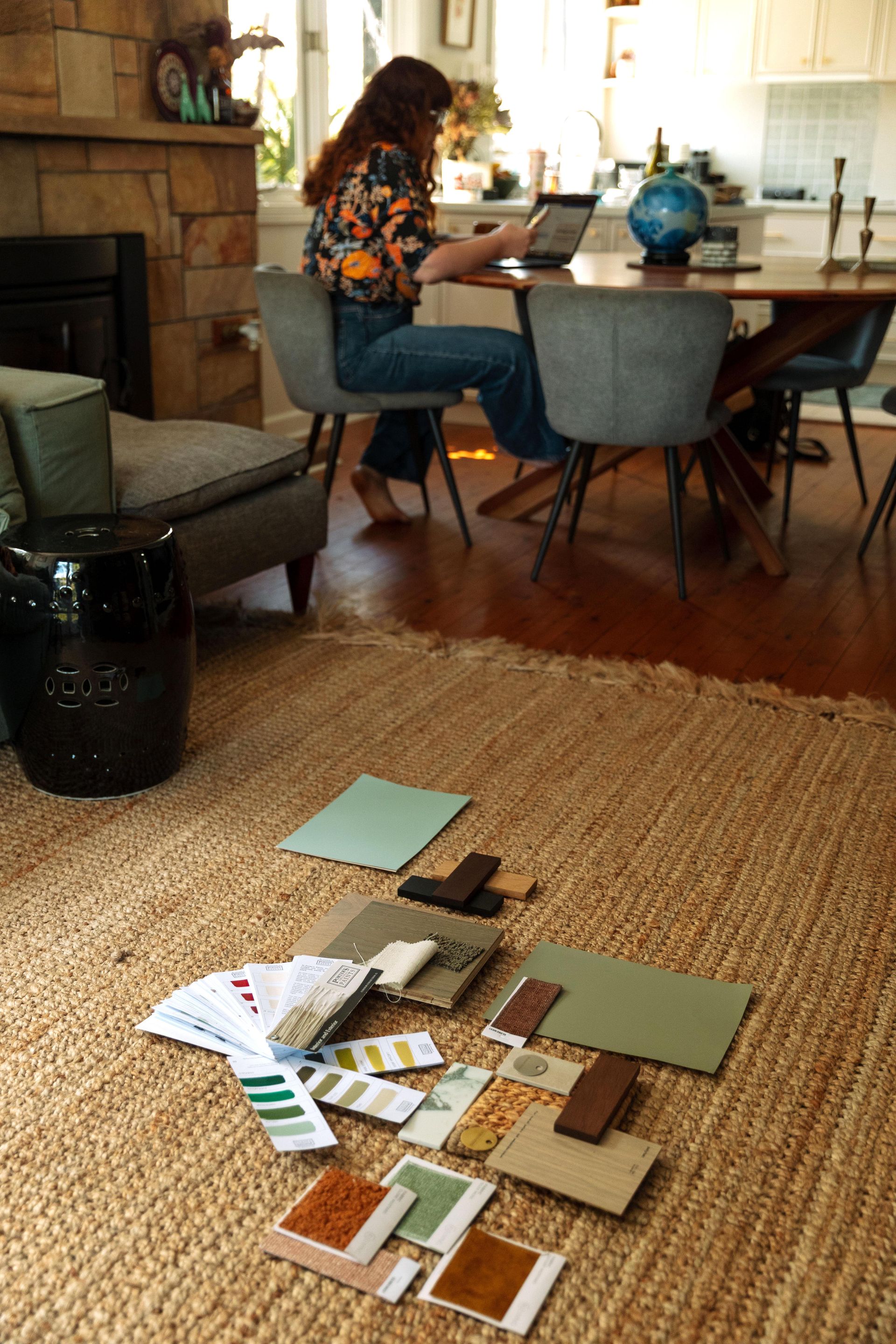 Person Working On A Laptop At A Dining Table In A Cozy Living Room — Everyday Interiors in Helensburgh, NSW