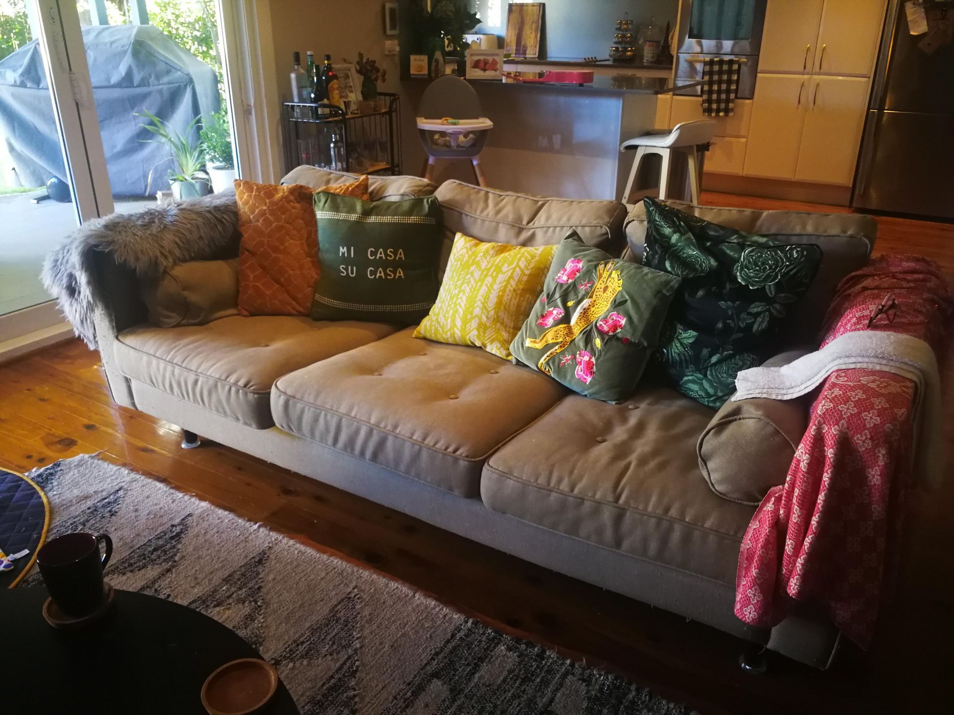 Living Room With Tan Sofa Covered In Colorful Pillows — Everyday Interiors in Helensburgh, NSW