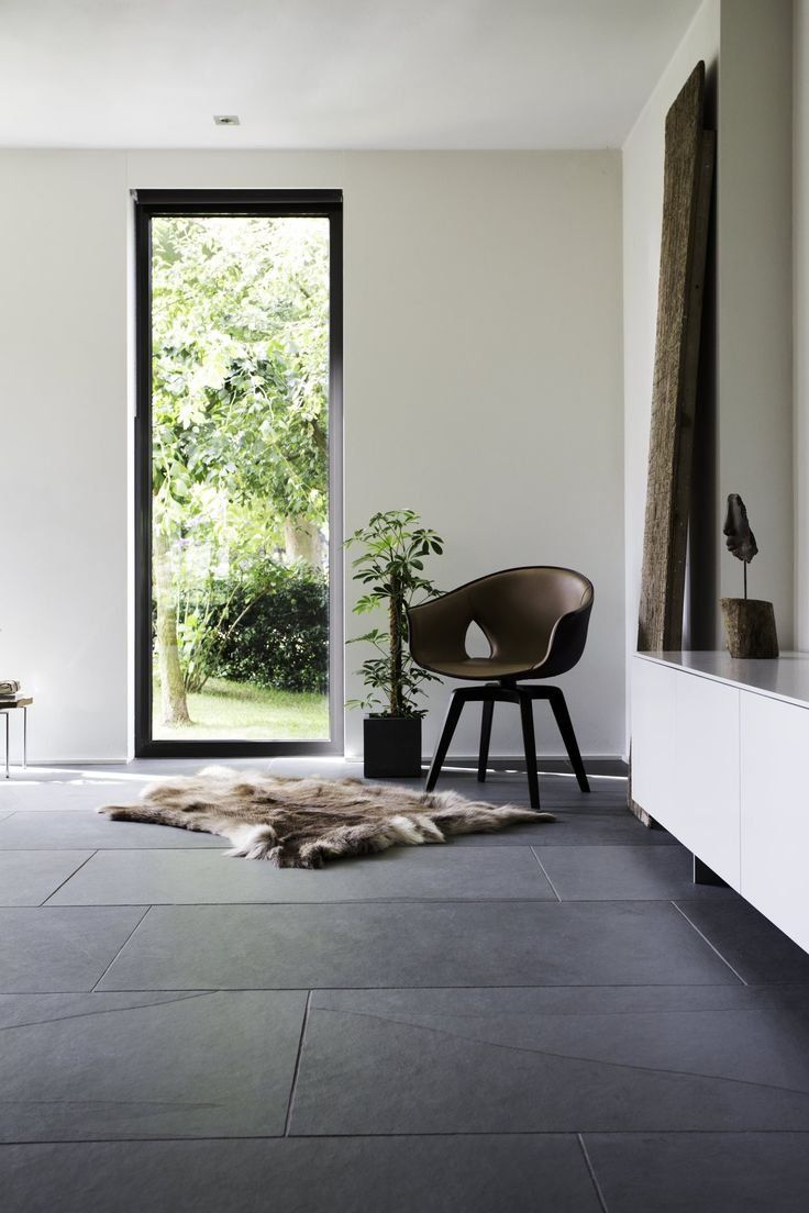 Minimalist Room With Dark Tile Floor, Chair And Large Open Doorway — Everyday Interiors in Helensburgh, NSW