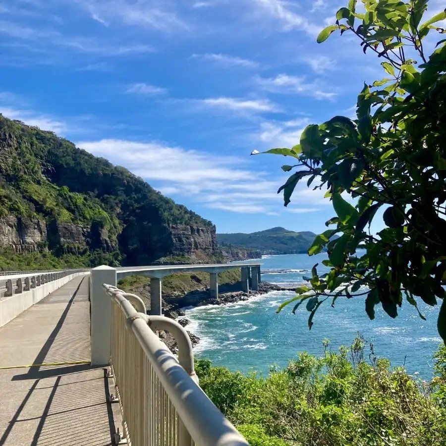 Coastal Walkway With Railings Beside Blue Ocean, Rocky Cliffs — Everyday Interiors in Helensburgh, NSW