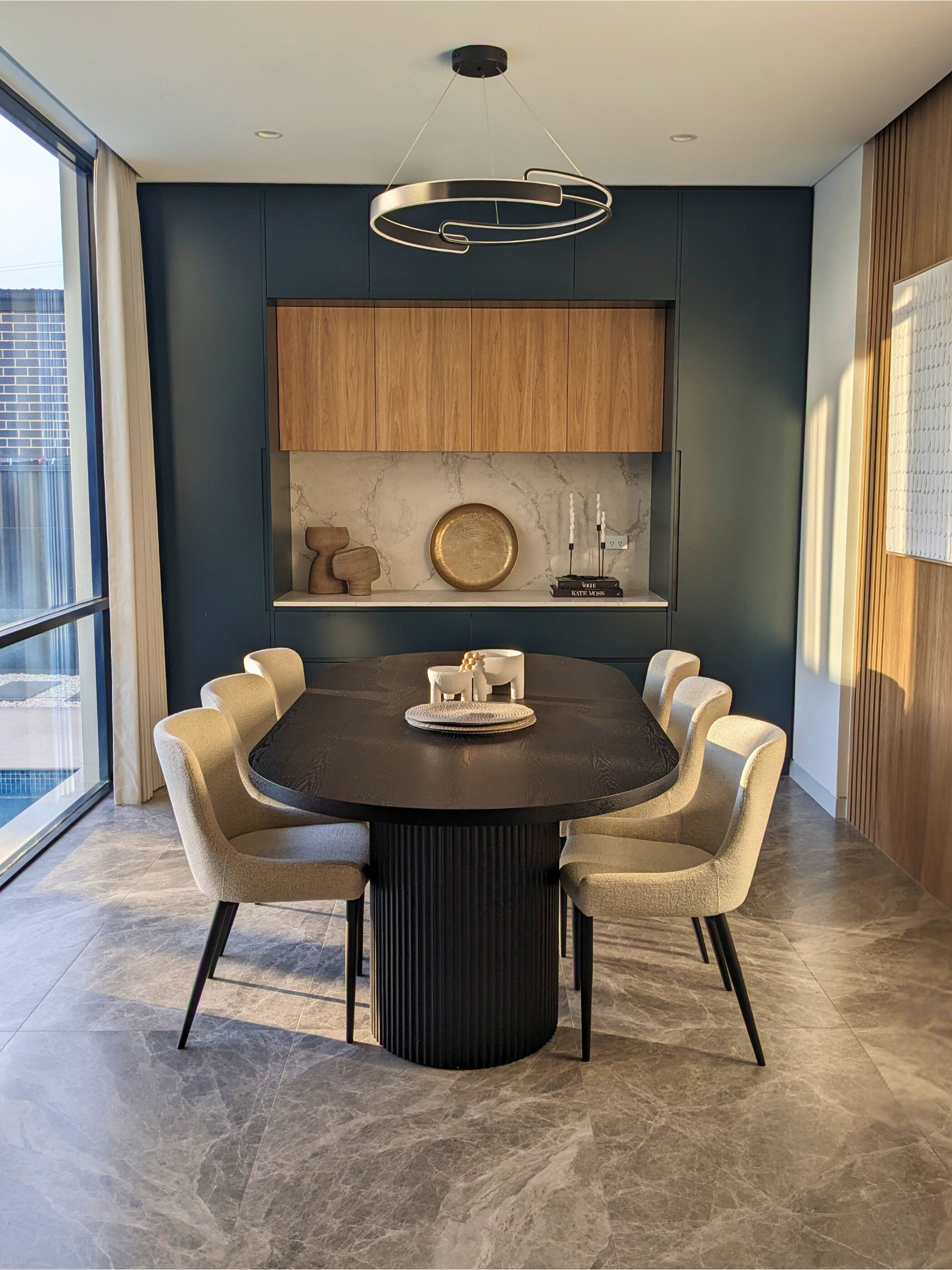 Modern Dining Room With A Round Black Table And Upholstered Chairs — Everyday Interiors in Helensburgh, NSW