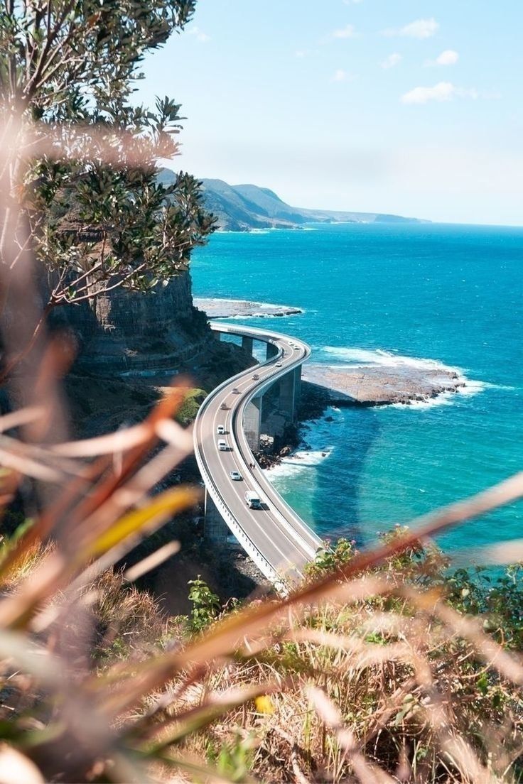 Coastal Highway Curving Along A Turquoise Ocean Beside Rocky Cliffs — Everyday Interiors in Helensburgh, NSW