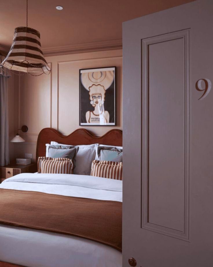 Cozy Bedroom With A Brown Bedspread And A Striped Lampshade — Everyday Interiors in Helensburgh, NSW