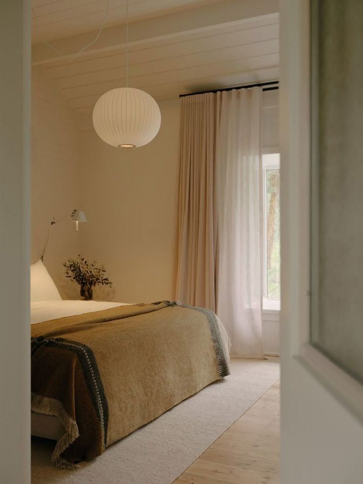 Minimal Beige Bedroom With A Bed And Pendant Light — Everyday Interiors in Helensburgh, NSW