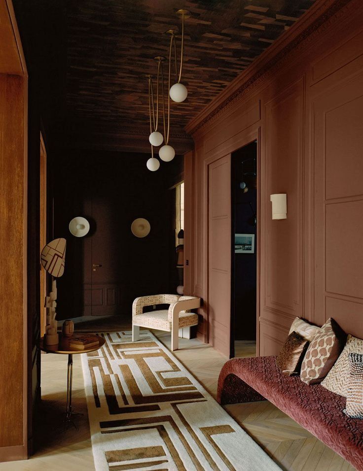 Dim Brown Hallway With Hanging Globe Lights And Patterned Rug — Everyday Interiors in Helensburgh, NSW