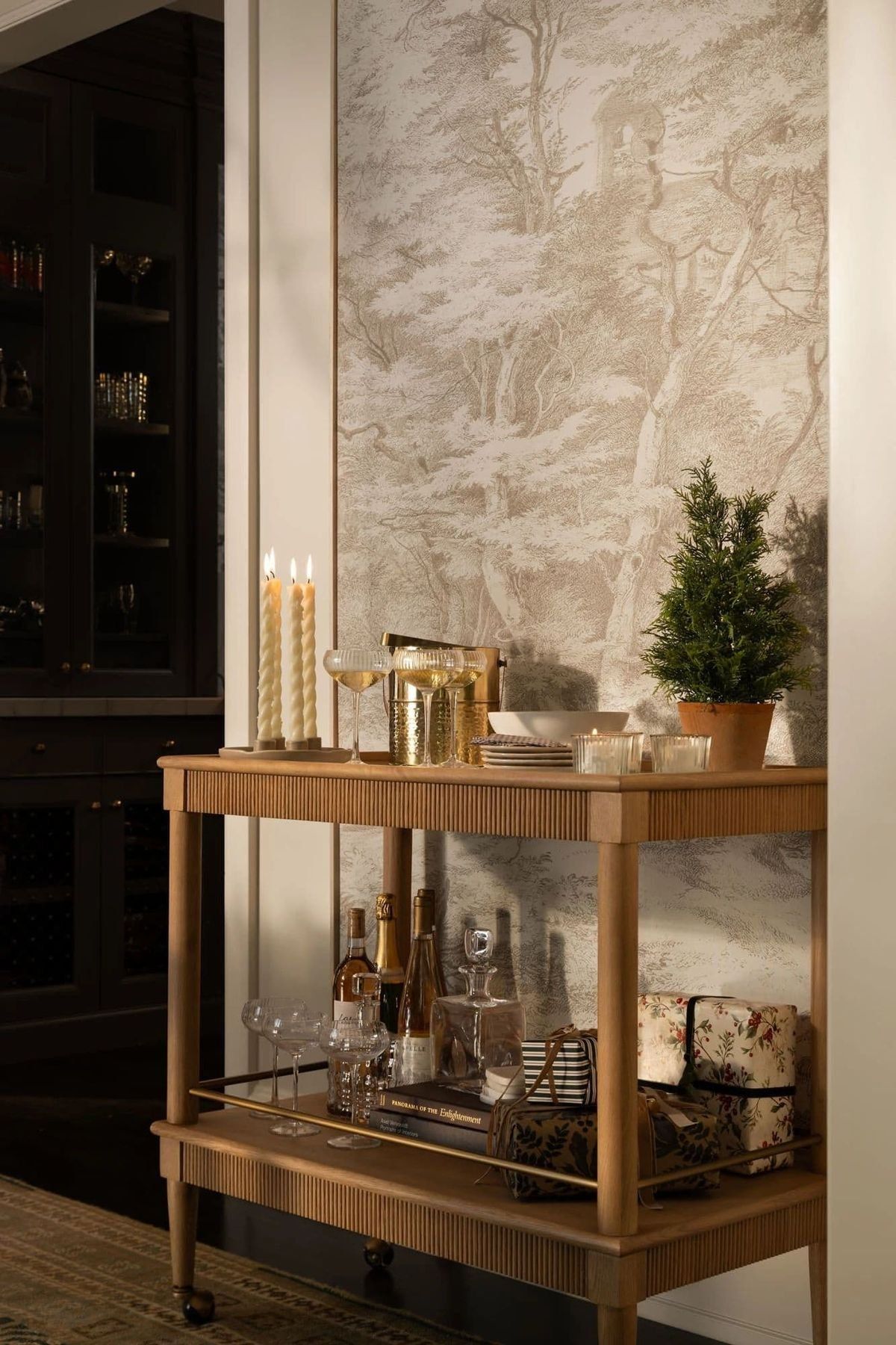 Wooden Bar Cart With Glasses And Bottles Beside A Textured Beige Wall — Everyday Interiors in Helensburgh, NSW