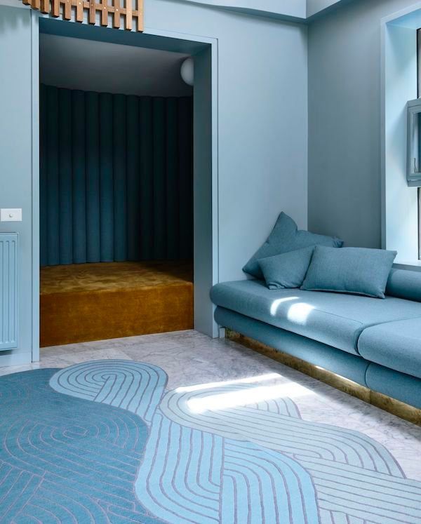 Blue Living Room With A Teal Sofa, Patterned Rug And A Doorway — Everyday Interiors in Helensburgh, NSW