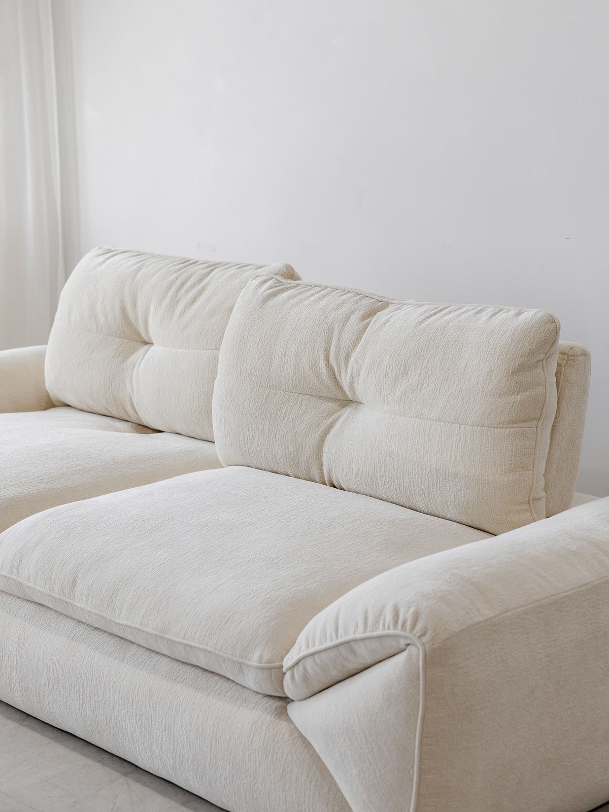 Cream Colored Upholstered Sofa With Tufted Back Cushions — Everyday Interiors in Helensburgh, NSW