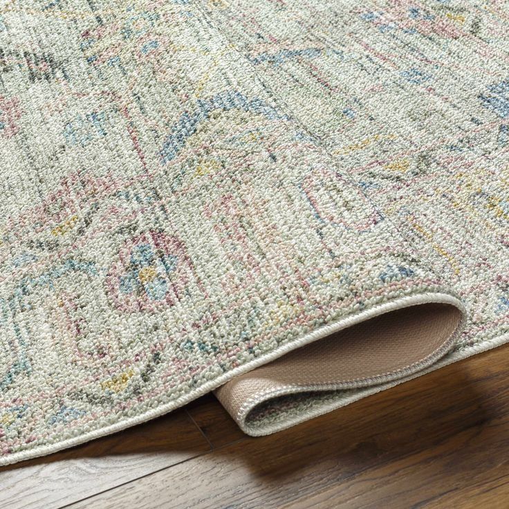 Folded Beige Patterned Rug Corner On A Wooden Floor — Everyday Interiors in Helensburgh, NSW