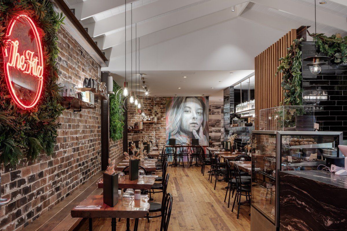 Cozy Brick Walled Café With Neon Sign And Wooden Tables — Everyday Interiors in Helensburgh, NSW