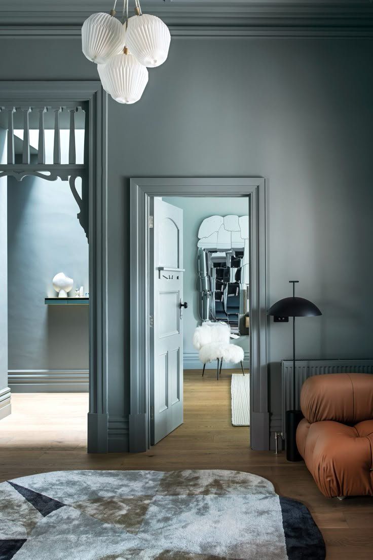 Stylish Gray Living Room With Doorway, Brown Sofa And Black Lamp — Everyday Interiors in Helensburgh, NSW