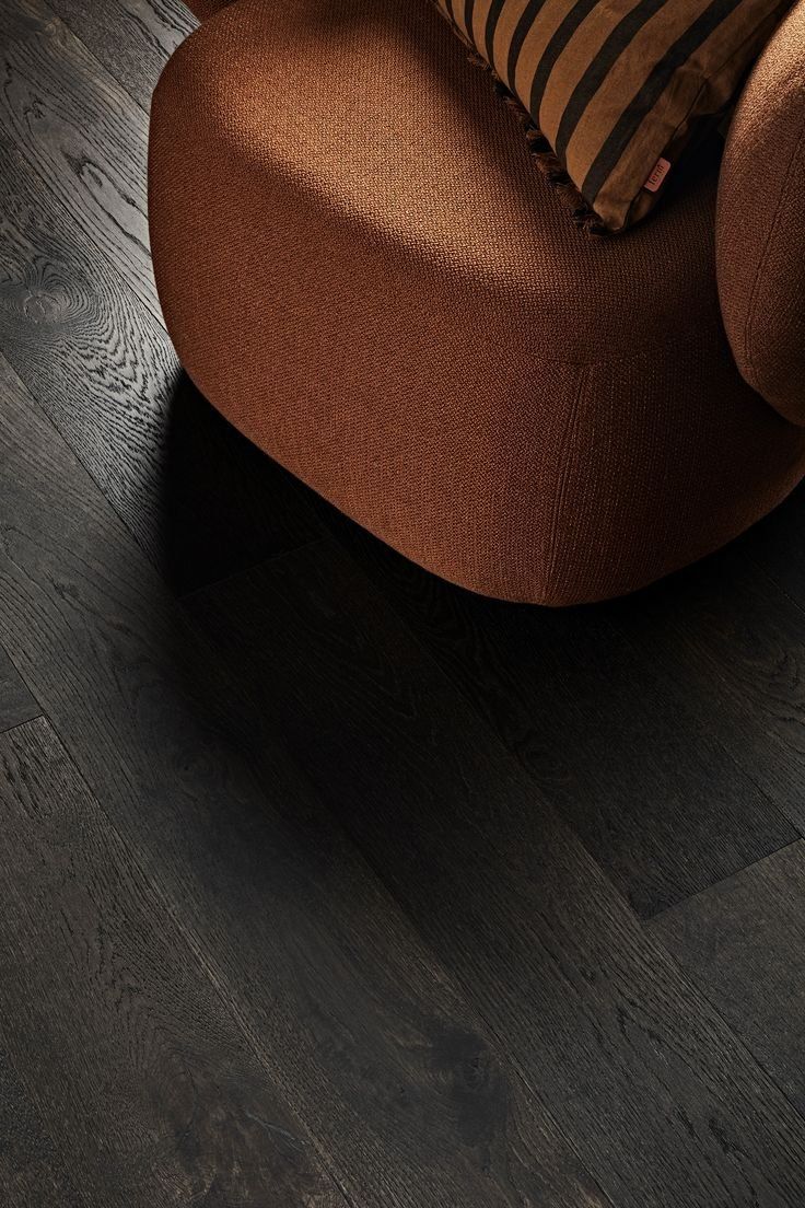 Brown Sofa Corner On A Dark Wood Floor With A Striped Cushion — Everyday Interiors in Helensburgh, NSW