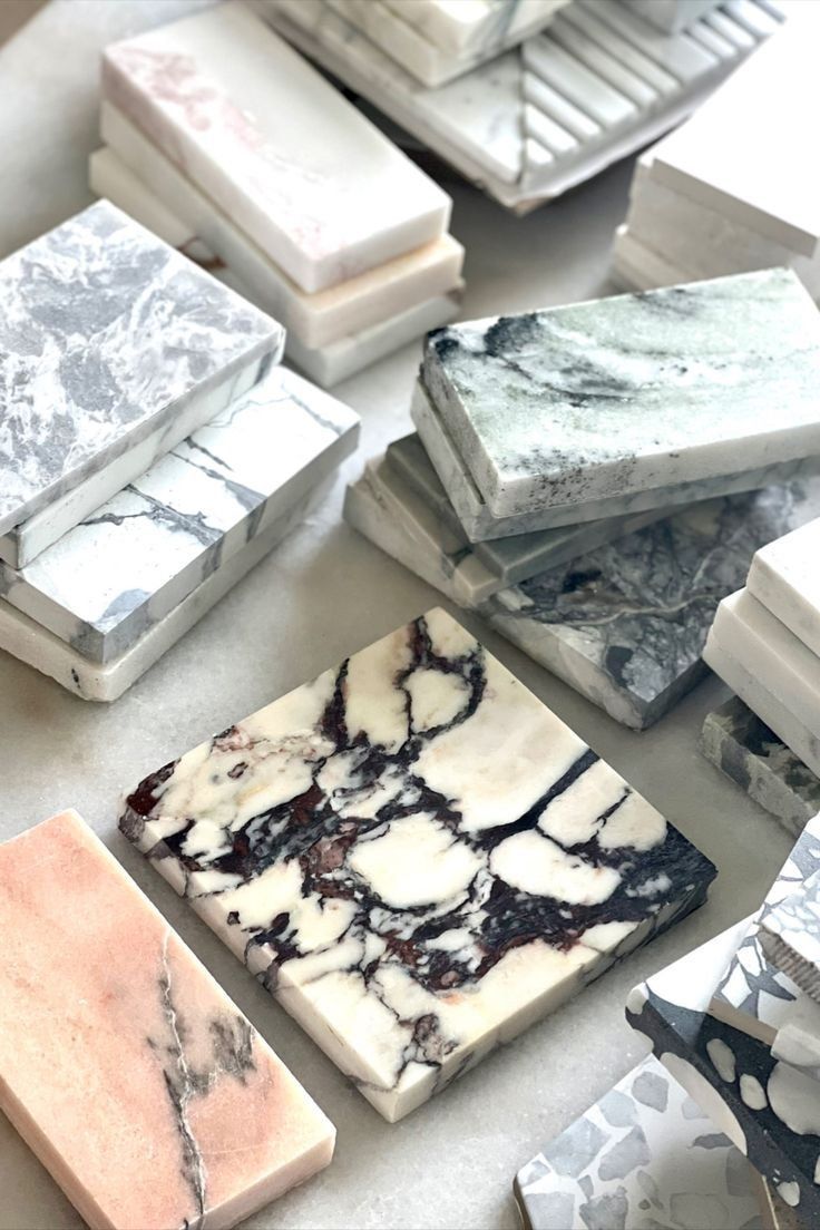 Assorted Polished Marble Tile Samples Stacked On A Table — Everyday Interiors in Helensburgh, NSW