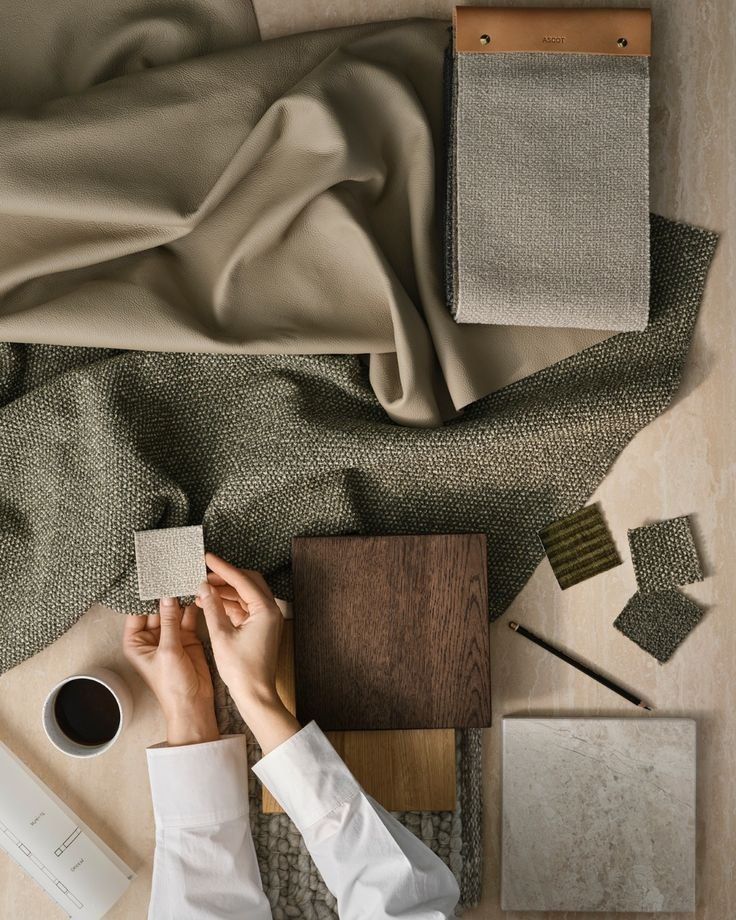 Hands Arranging Fabric Swatches And Materials On A Table — Everyday Interiors in Helensburgh, NSW