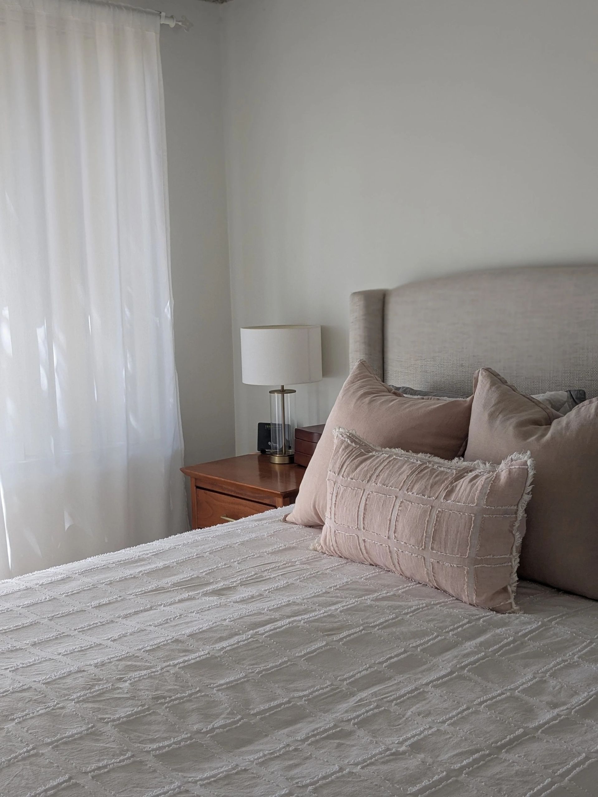 Cozy Bedroom With A Neatly Made Bed, Pink Pillows And A White Lamp — Everyday Interiors in Helensburgh, NSW