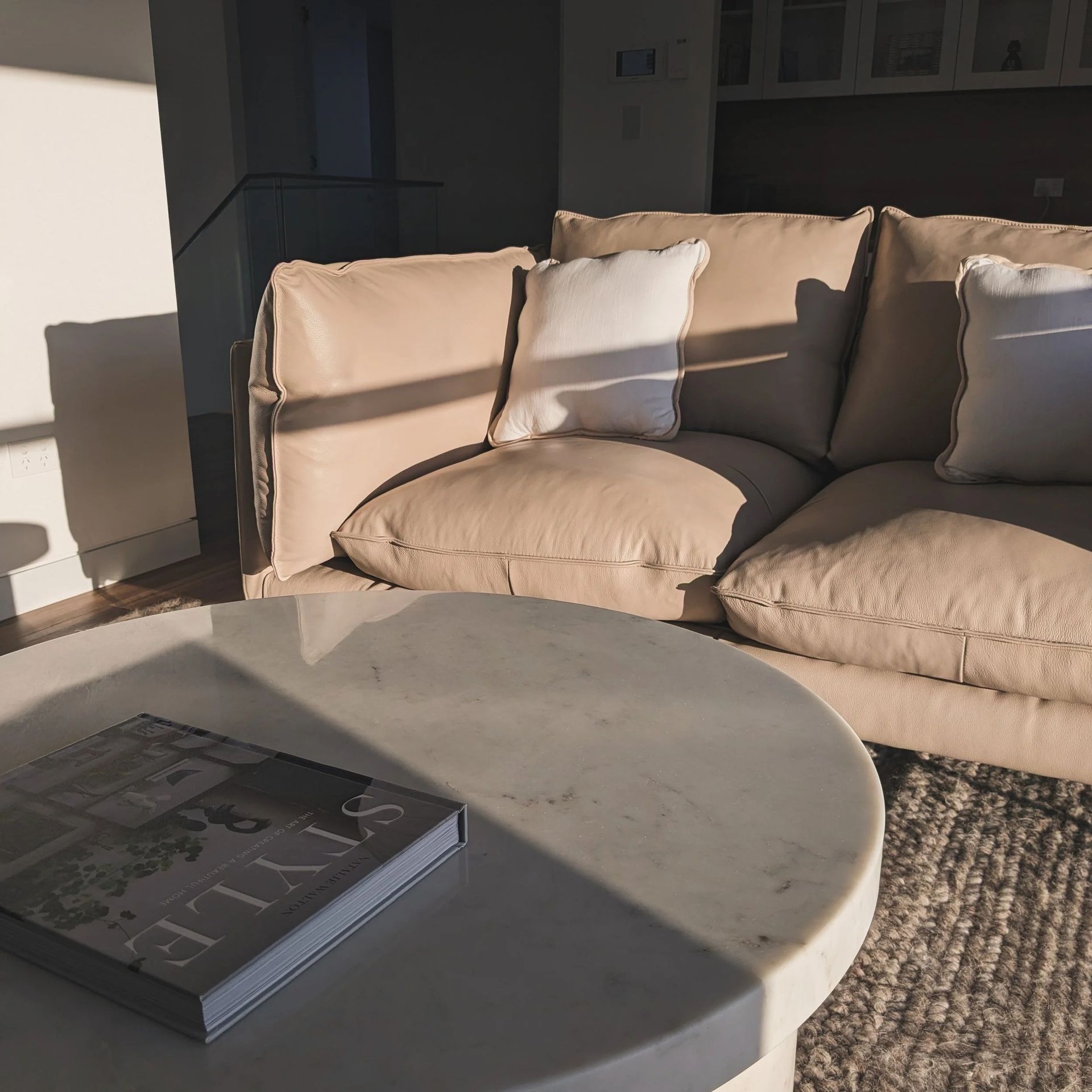 Sunlit Patio With Beige Sectional Sofa And Round Coffee Table — Everyday Interiors in Helensburgh, NSW