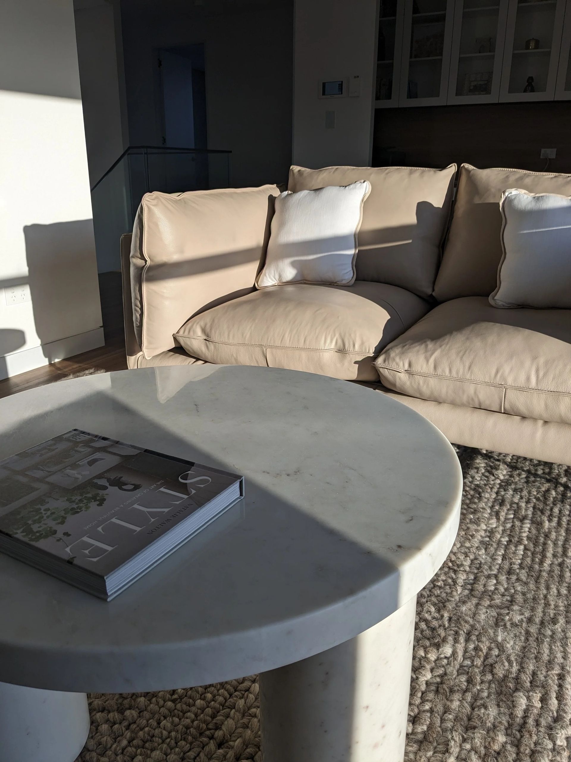 Sunlit Patio With Beige Sofa And Round Gray Table — Everyday Interiors in Helensburgh, NSW