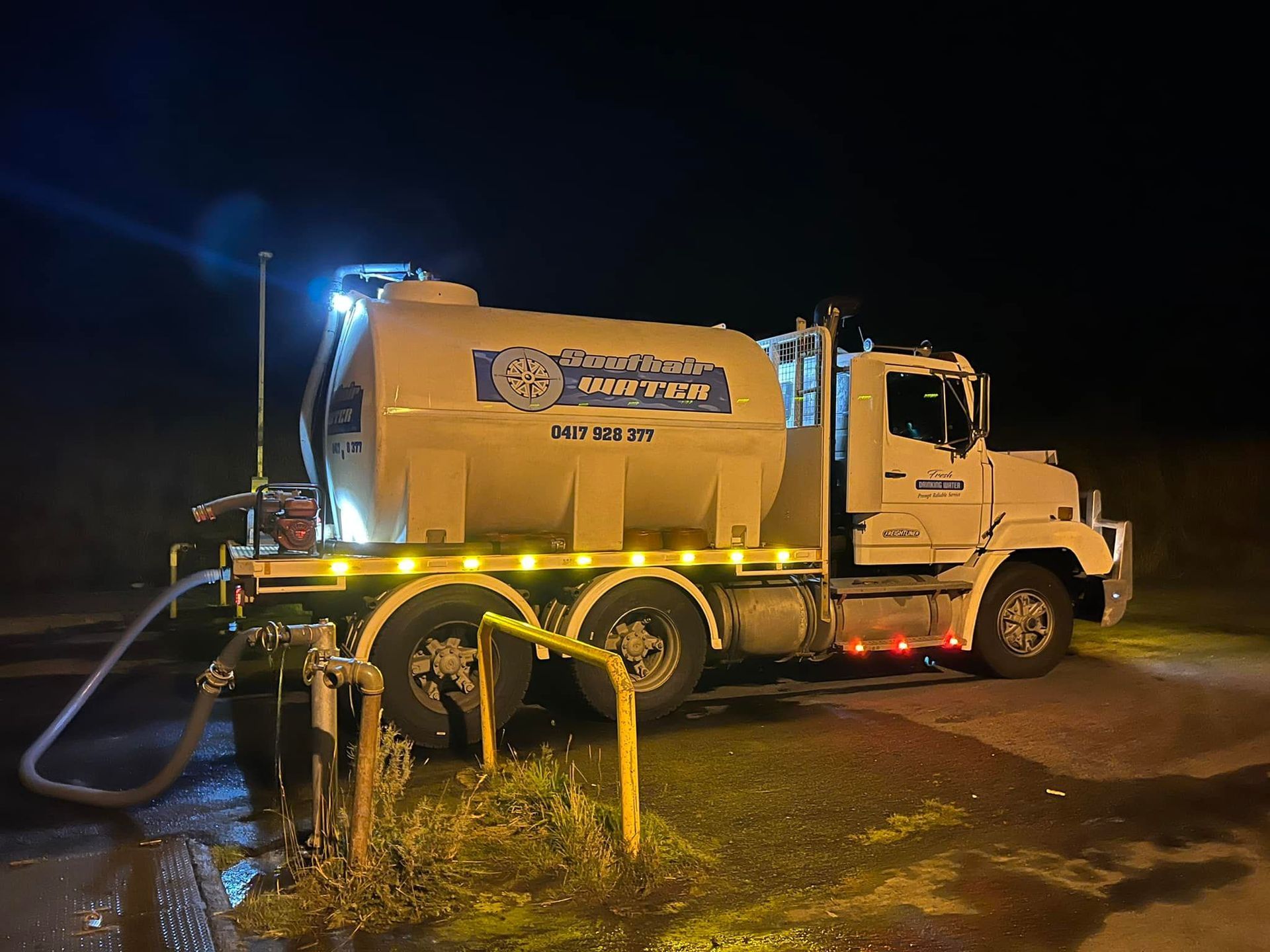 A White Tanker Truck Parked at Night, Connected by a Hose — SOUTHAIR WATER In Mornington, TAS