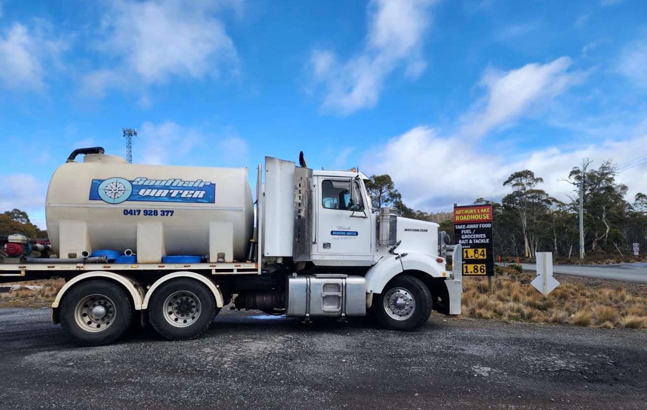 A White Tanker Truck Parked on a Gravel Surface — SOUTHAIR WATER In Mornington, TAS