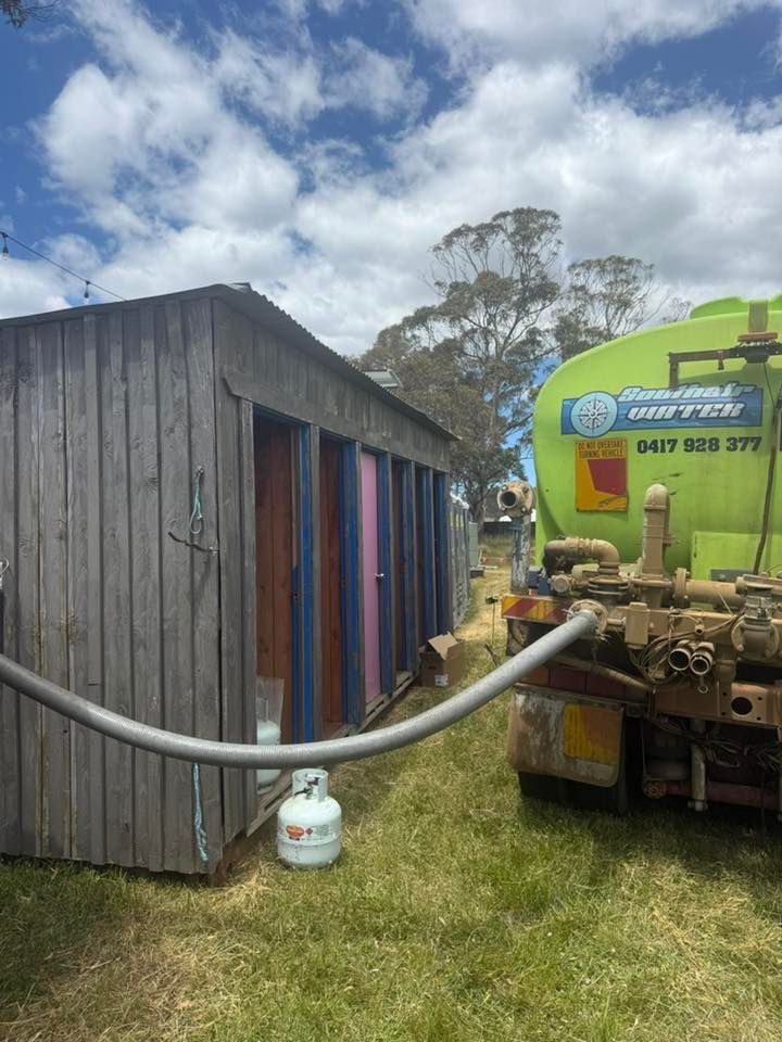 A Water Tanker Truck Parked Next to a Wooden Shed — SOUTHAIR WATER In Mornington, TAS