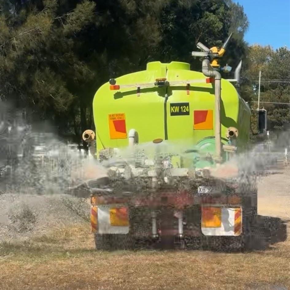 A Bright Yellow Water Tanker Truck Spraying a Fine Mist of Water — SOUTHAIR WATER In Mornington, TAS
