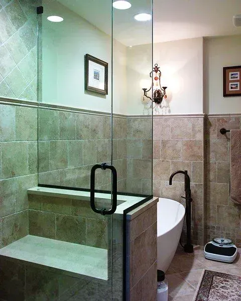 Modern bathroom with glass shower, white tub, tiled walls, and wall sconce lighting in Modern kitchen with gray cabinets, island, pendant lights, exposed wood beams, and two barstools in Arlington Heights, IL.