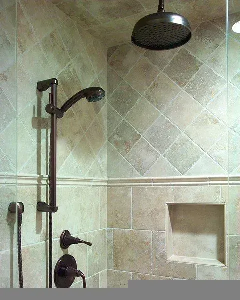 Walk-in shower with bench, grab bars, handheld showerhead, and dark round rain showerhead on tiled walls in a modern kitchen with gray cabinets, island, pendant lights, exposed wood beams, and two barstools in Arlington Heights, IL.
