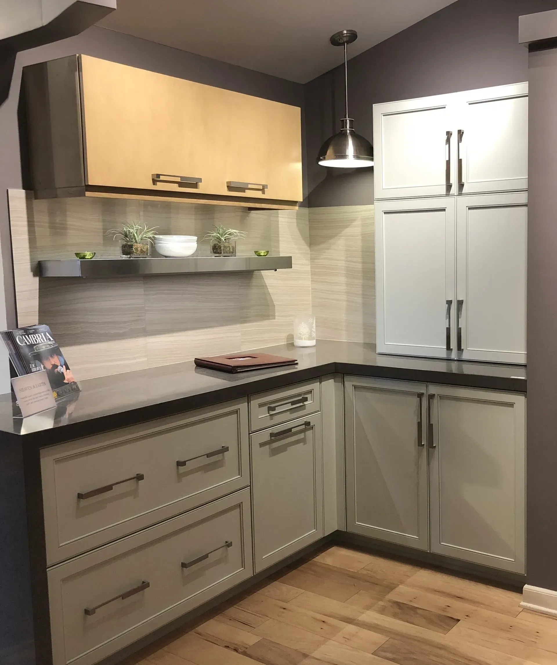 Modern kitchen corner with gray cabinets, light wood uppers, white countertop, and floating shelves in Modern kitchen with gray cabinets, island, pendant lights, exposed wood beams, and two barstools in Arlington Heights, IL.