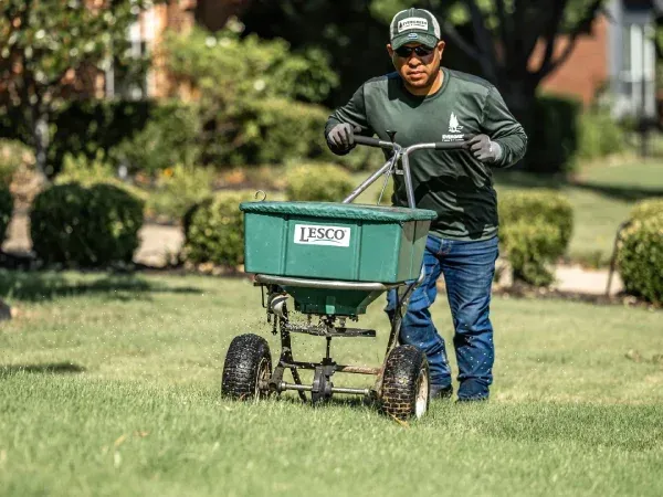 Lawn fertilization treatment in Argyle TX enriching soil nutrients for thicker greener and healthier grass