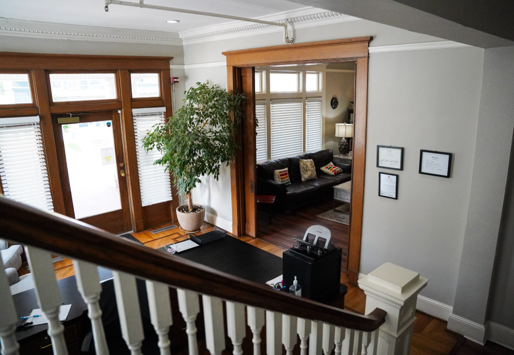 A view of a living room from the top of a staircase.