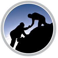 A silhouette of two people helping each other climb a mountain