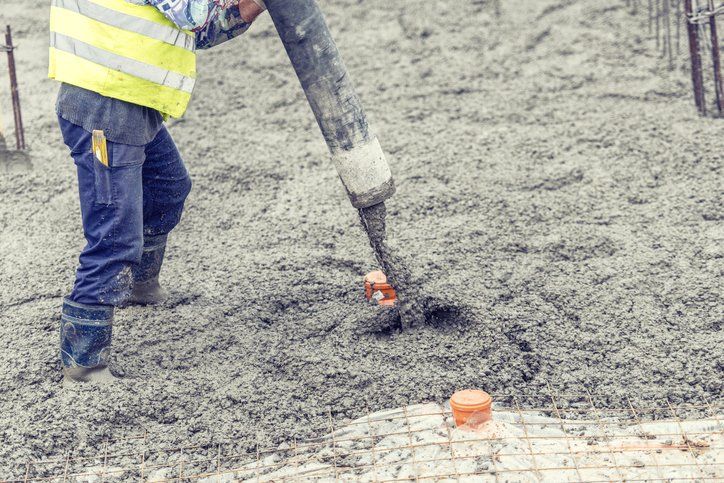 Worker pouring concrete