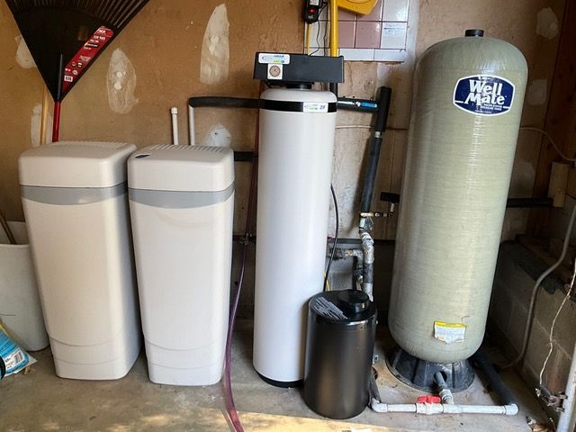 A water treatment system is sitting in a garage.