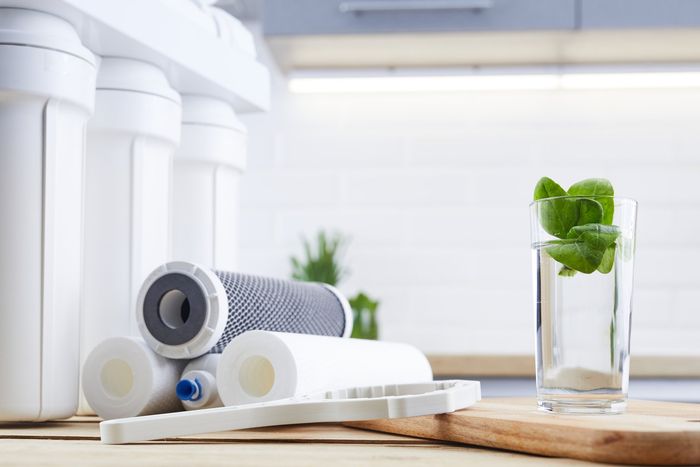 A glass of clean water with osmosis filter and cartridges
