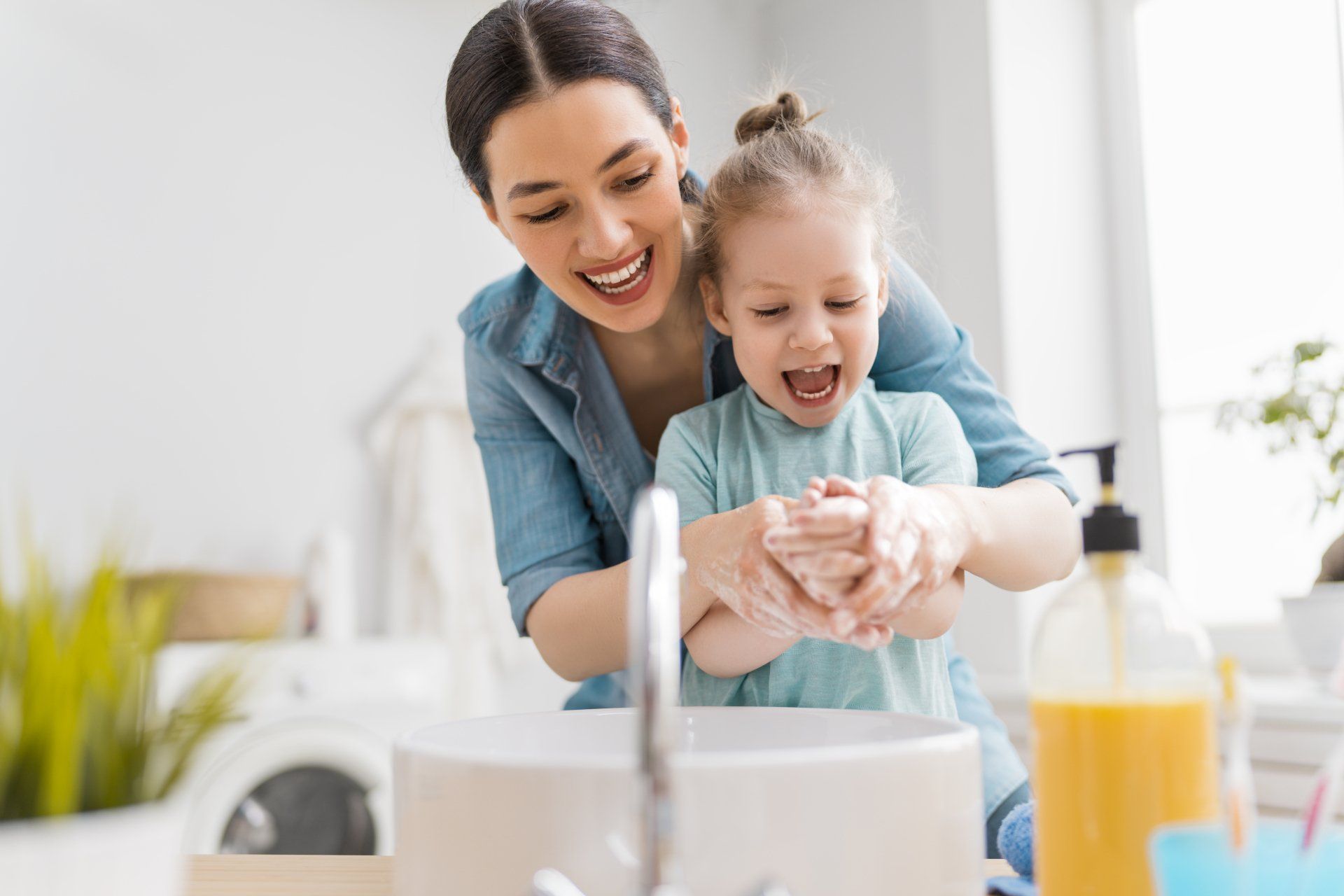 Mother and daughter washing hands