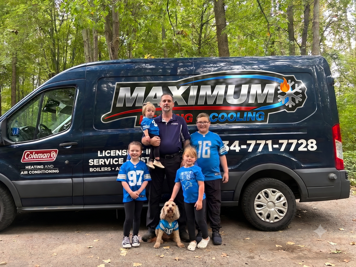 Family posing beside a black Maximum van in a wooded area, with a dog in front.