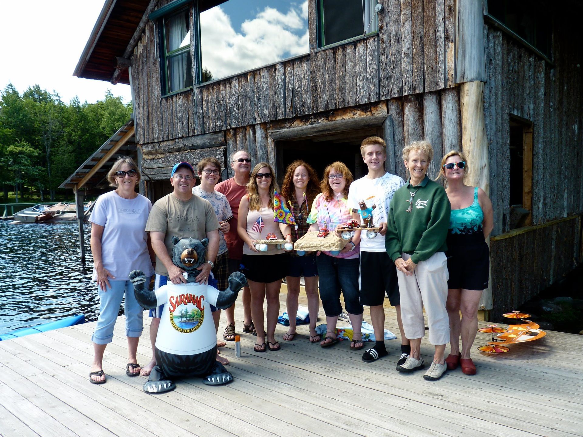 group of people on a dock holding silly rafts