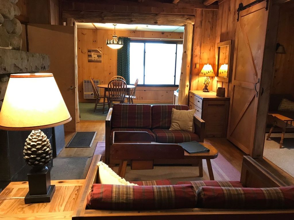 a living room with a couch , table and lamp