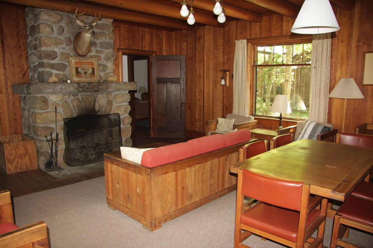 a living room with a stone fireplace and a couch